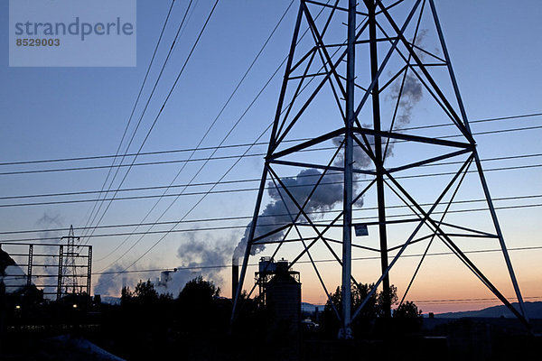 Silhouette von Hochspannungsleitungen und Pylonen bei Sonnenaufgang