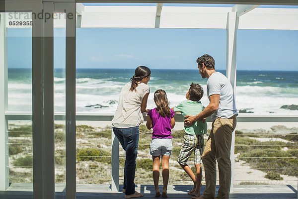 Familie genießt Meerblick von der Terrasse aus