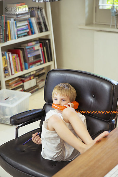 Junge spricht am Telefon