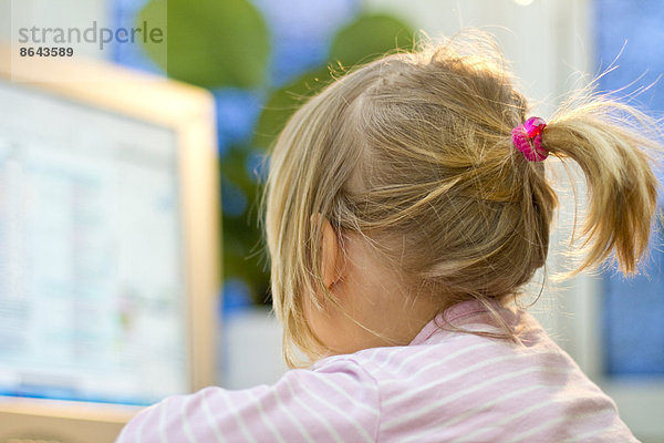 Blondes Mädchen vor einem Computer