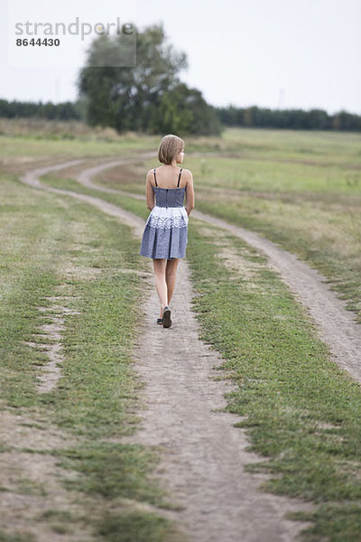 Teenager-Mädchen läuft auf Feldweg