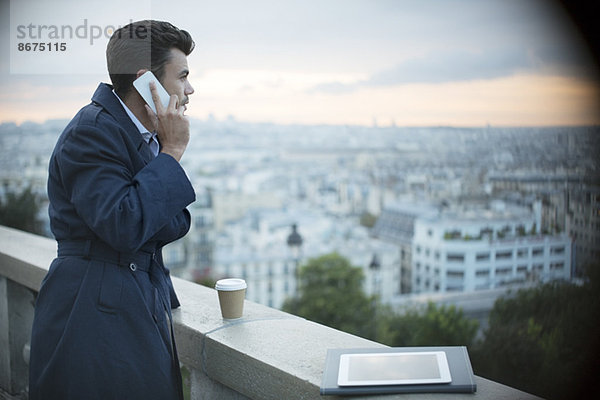 Geschäftsmann am Handy mit Blick auf Paris  Frankreich