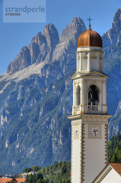 Church tower of Auronzo di Cadore with Tre Cime di Lavaredo  Dolomites  Italy