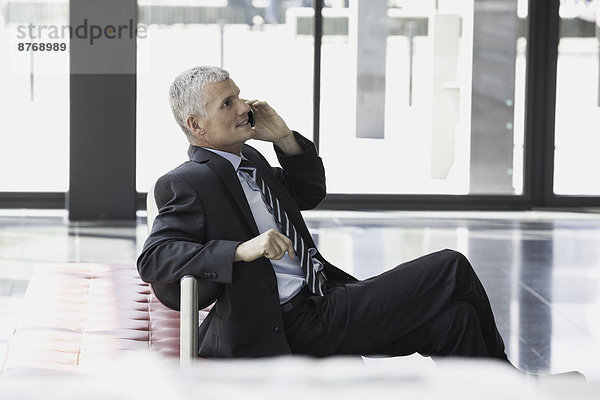 Mature businessman on cell phone