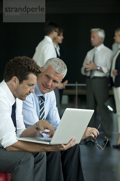 Two businessmen with laptop