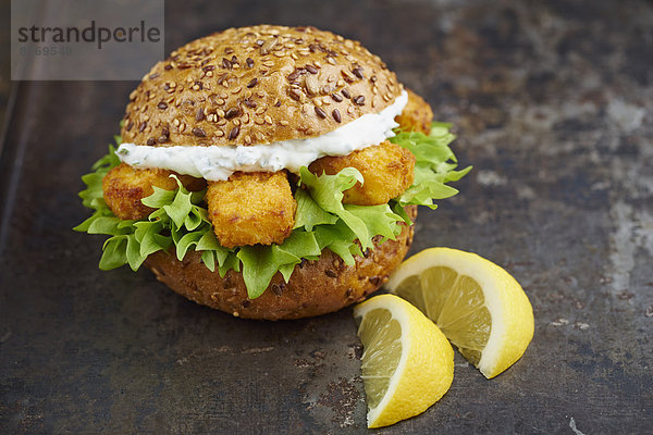 Burger with fish fingers and herb curd