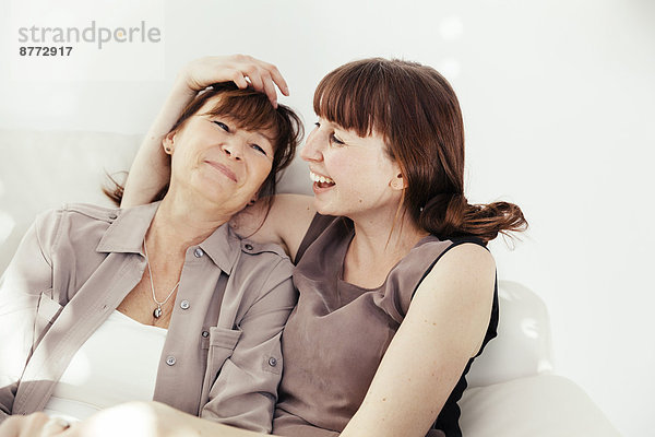 Portrait of mother and daughter laughing together