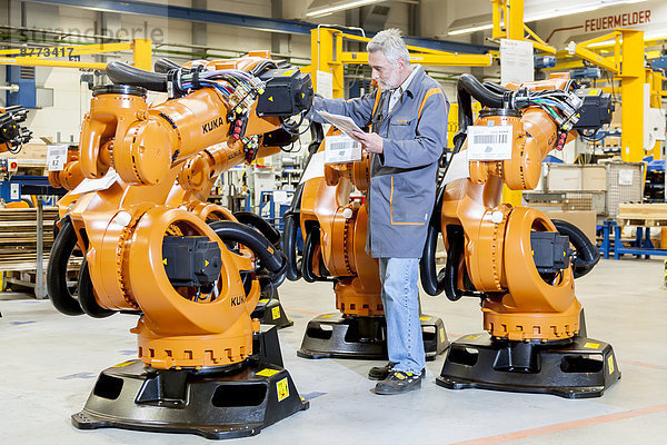 Ein Mitarbeiter des Roboterherstellers KUKA AG bei der Komplettierung der Versandpapiere vor der Auslieferung von KUKA-Robotern  Augsburg  Bayern  Deutschland