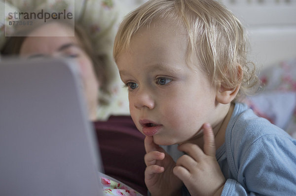 Toddler looking at digital tablet