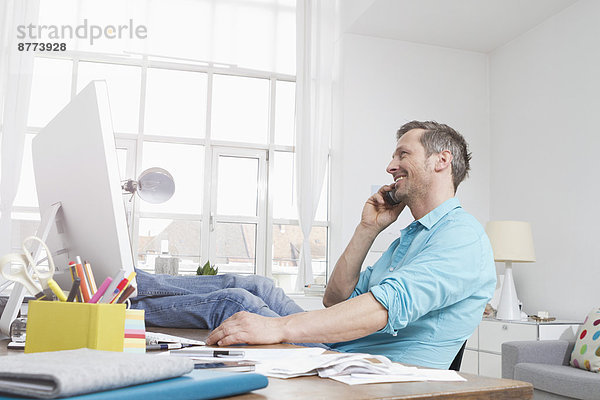 Man at desk on the phone