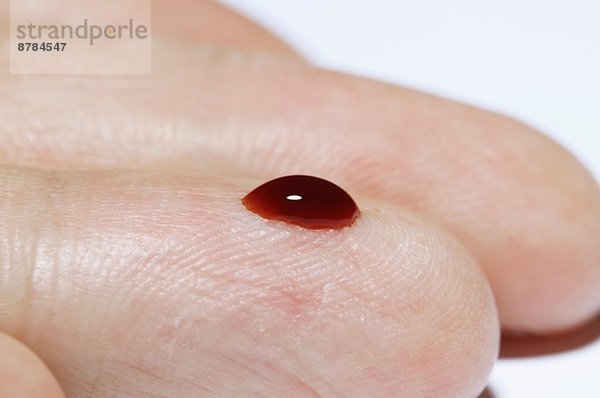 (Synthetisch) Blutstropfen an einem männlichen Finger