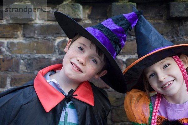 Portrait von Junge und Mädchen in Halloween-Kostümen