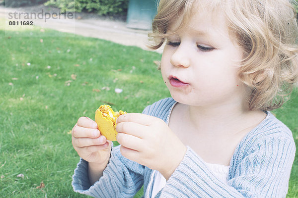 Kleines Mädchen isst Makrone