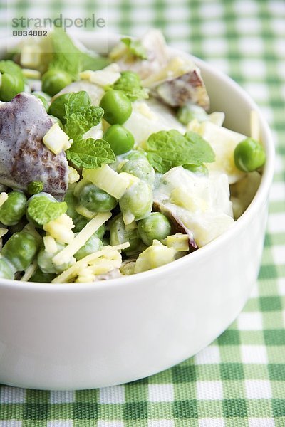 Minted pea and potato salad in bowl