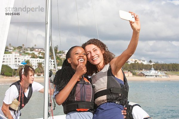 Zwei junge Freundinnen beim Selbstporträt mit Segelboot