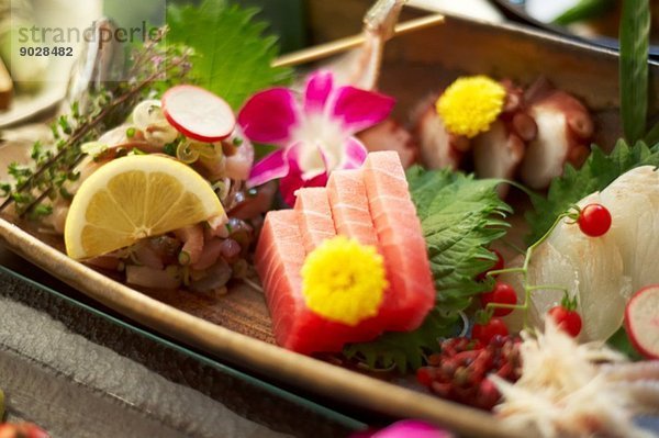 Stilleben von rustikalem Essen mit rohem Fisch  Obst und Blumen
