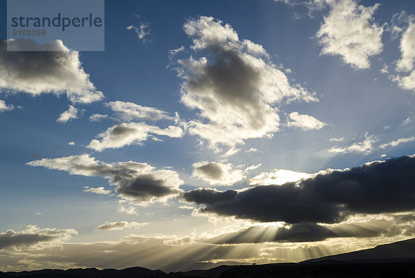 Sonnenstrahlen brechen durch die Wolken im Abendlicht  bei Barrydale  Route 62  Provinz Westkap  Südafrika