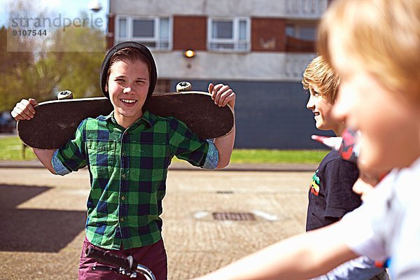 Junge hält Skateboard