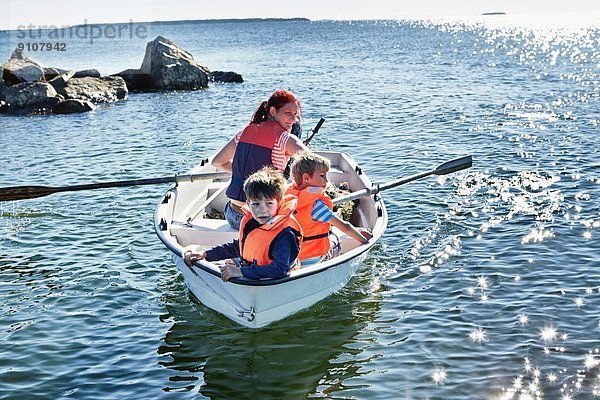 Mutter und zwei junge Söhne im Ruderboot auf dem See  Gavle  Schweden