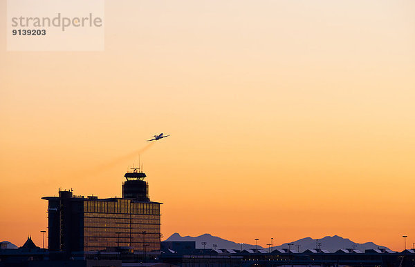 Control tower and outbound aircraft  Vancouver International airport.
