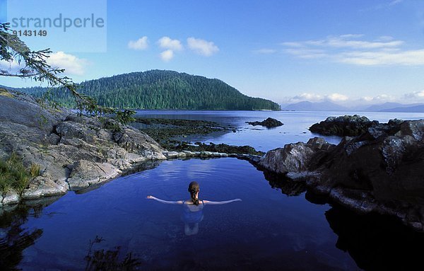 Woman in natural hotspring pool  Gwaii Haanas National Park  Queen Charlotte Islands  British Columbia  Canada