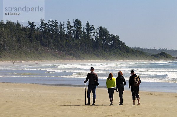 nahe Nationalpark 4 Mensch Menschen gehen Strand lang langes langer lange Pazifischer Ozean Pazifik Stiller Ozean Großer Ozean vorwärts Tofino British Columbia
