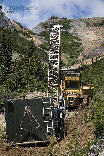 Bulldozer moving diamond drilling rig  Astlais mountain  BC