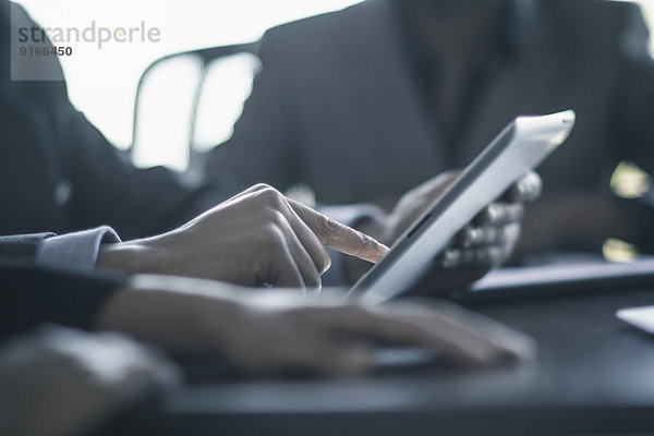 Businessman using digital tablet in meeting