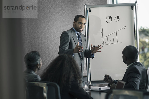 Businessman talking to colleagues in meeting