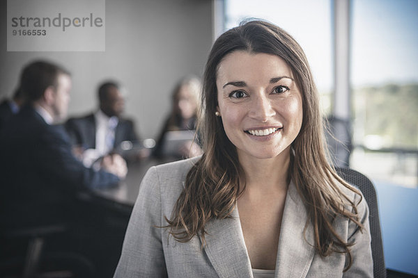 Businesswoman smiling in conference room