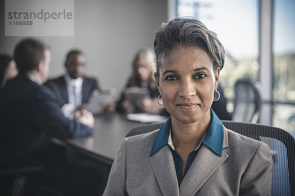 Businesswoman smiling in conference room