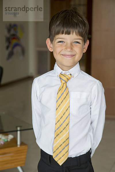 Caucasian boy smiling in formal wear