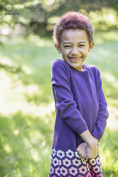 Mixed race girl smiling outdoors