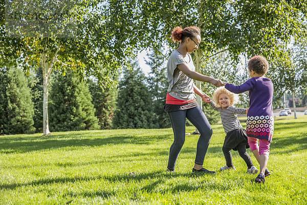 Mixed race sisters playing outdoors