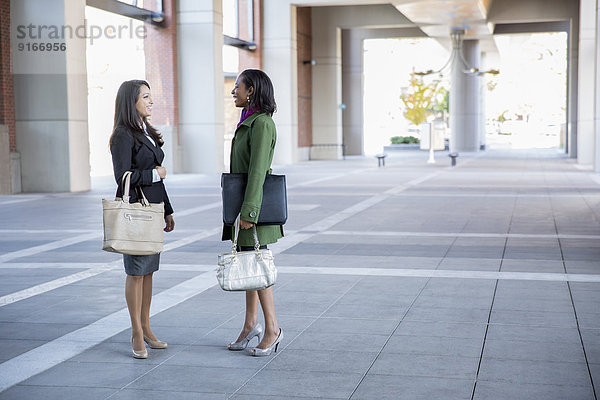 Businesswomen talking outdoors