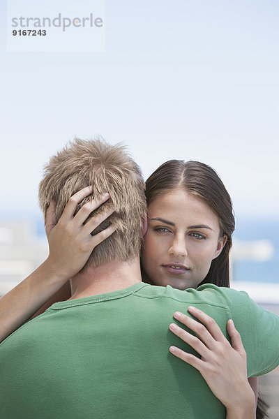 Caucasian couple hugging outdoors