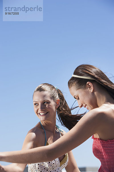 Caucasian women dancing outdoors