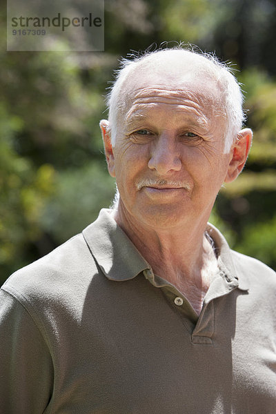 Senior Caucasian man smiling outdoors