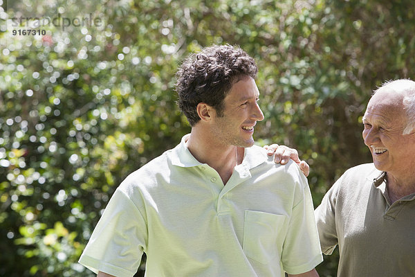 Caucasian father and son walking in park