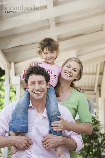 Caucasian family smiling on porch
