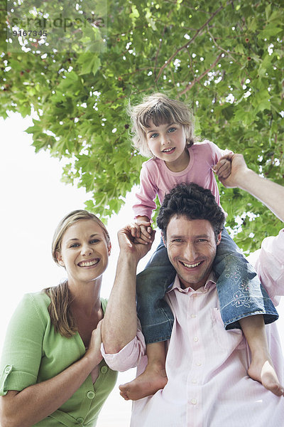 Caucasian family smiling outdoors