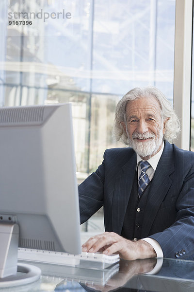 Senior Caucasian businessman working at desk
