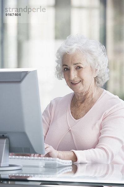 Senior Caucasian businesswoman working at desk