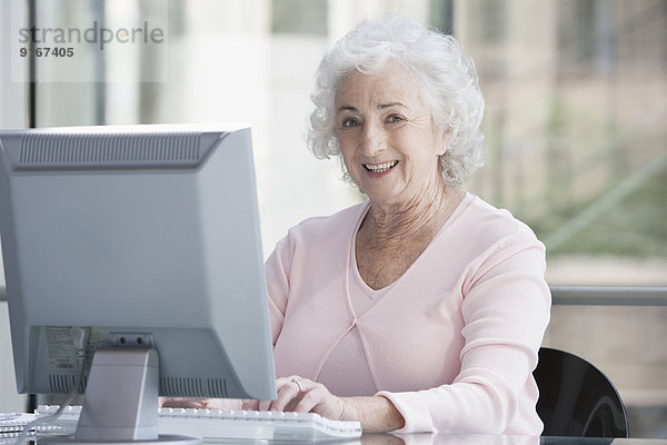 Senior Caucasian businesswoman working at desk