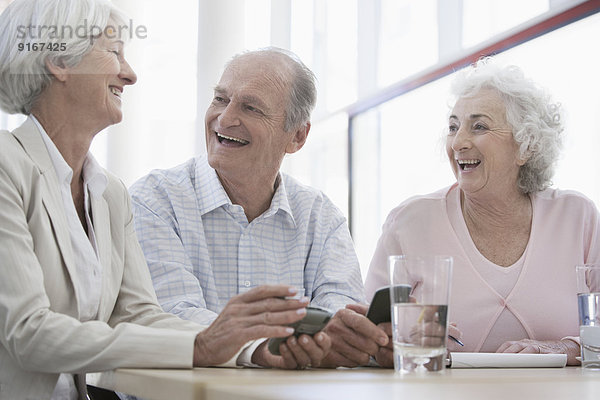 Senior Caucasian friends laughing in cafe