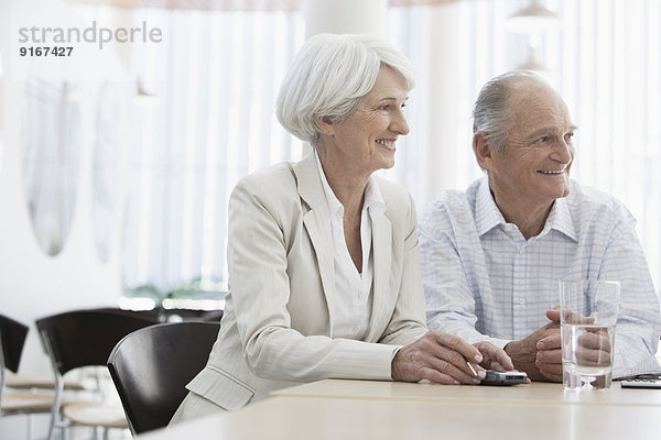 Senior Caucasian couple smiling in cafe