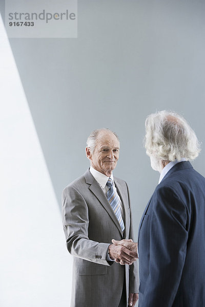 Senior Caucasian businessmen shaking hands