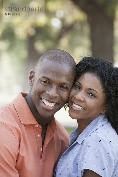 Couple hugging in park