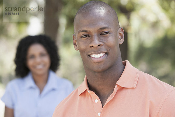 Man smiling in park