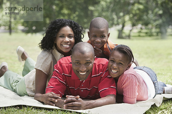 Family relaxing together in park